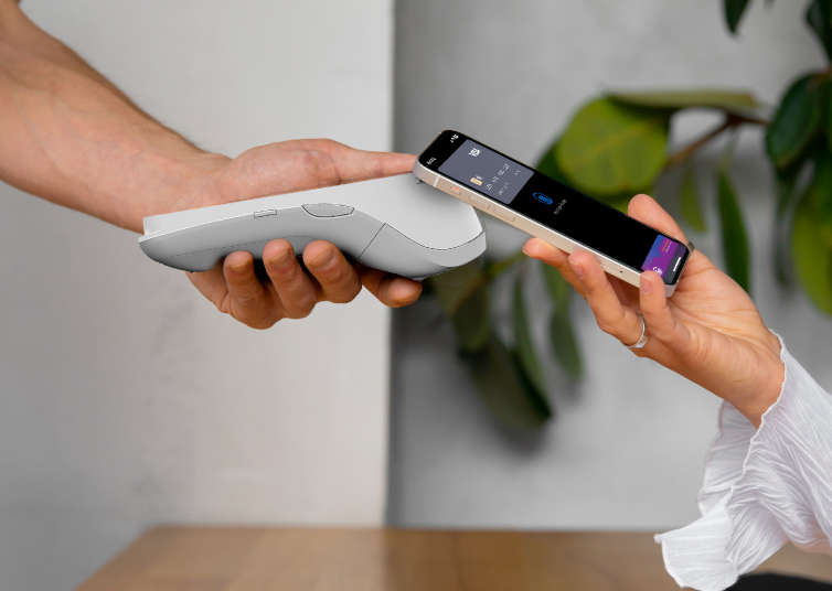 NFC contactless technology makes a payment at a card reader.