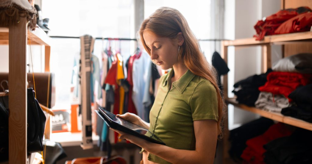 a woman uses a mobile EPOS for retail shops