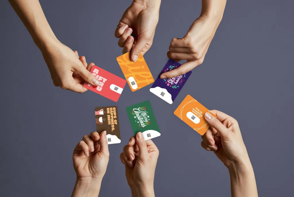 sell gift cards for your business in ireland multiple customers holding npi gift cards