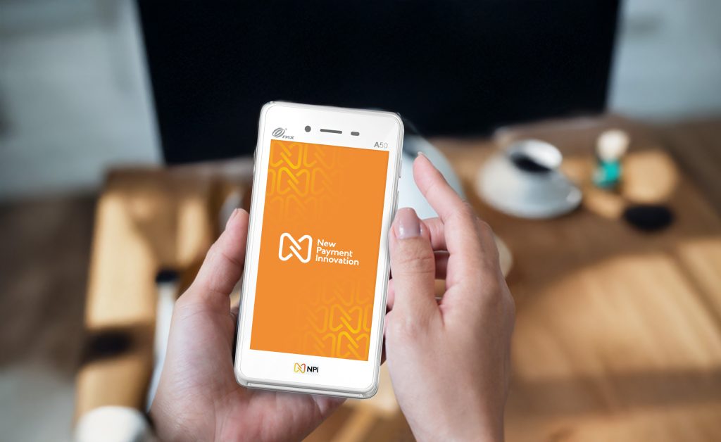 Hand holding PAX A50 card machine integrated with online payment gateway Ireland for seamless omnichannel retail transactions