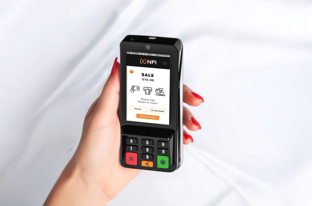 Hand using open banking payments Ireland technology with NPI card machine for contactless transaction