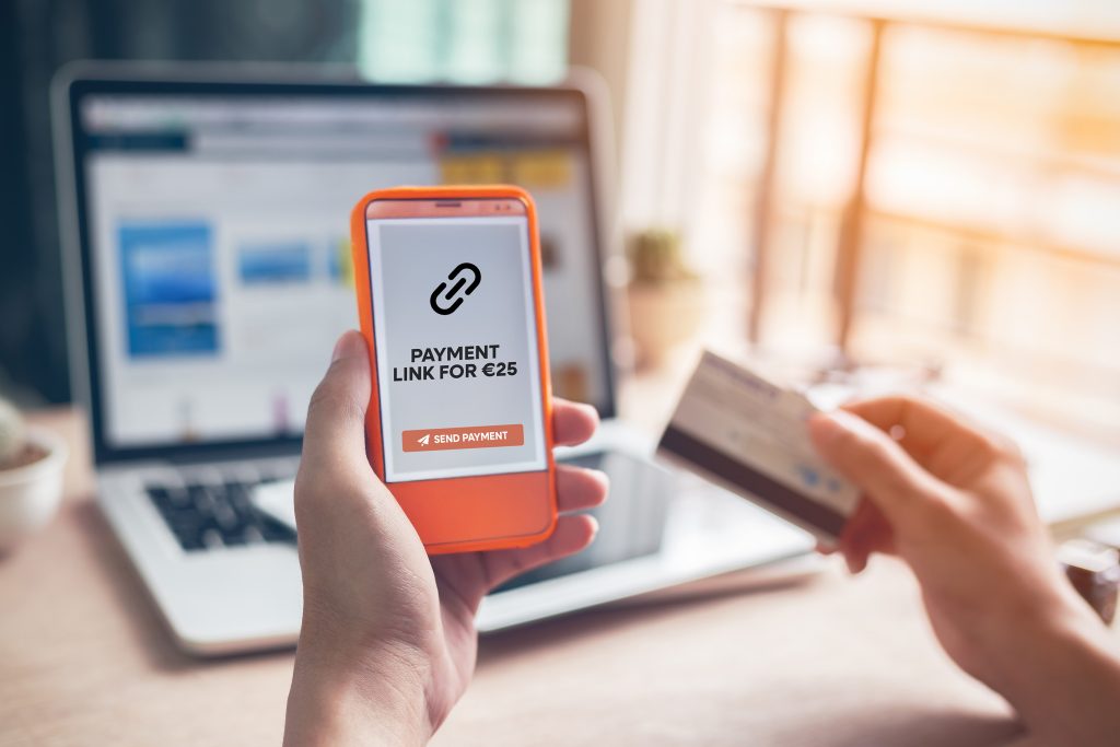 Payment links Ireland secure mobile payment with person holding phone showing payment link screen and credit card ready
