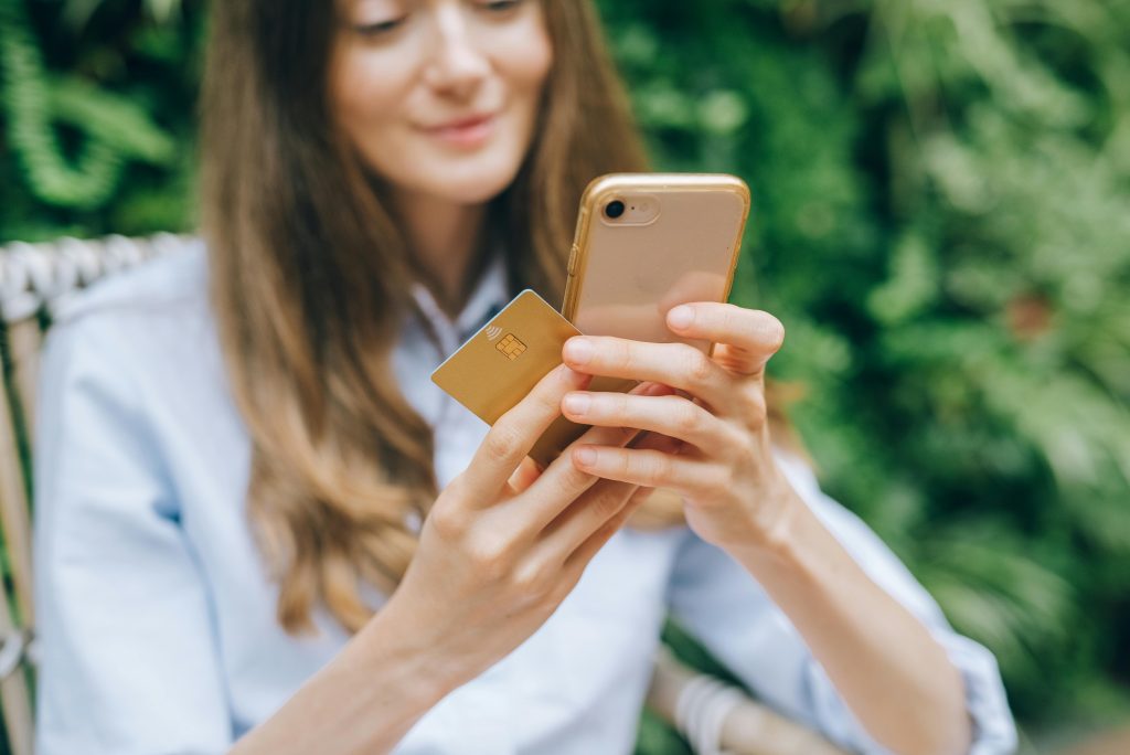 Online payment systems person making secure mobile payment on phone holding credit card demonstrating digital transactions