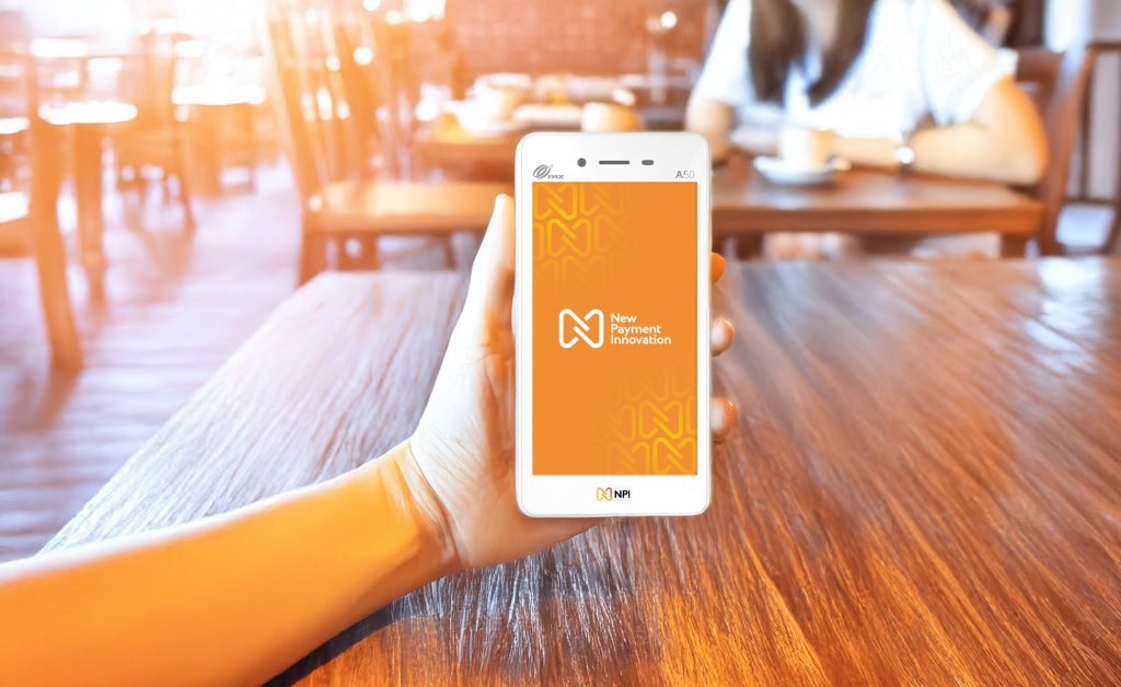 Hand holding PAX A50 card machine on restaurant counter for merchant services Ireland payment processing