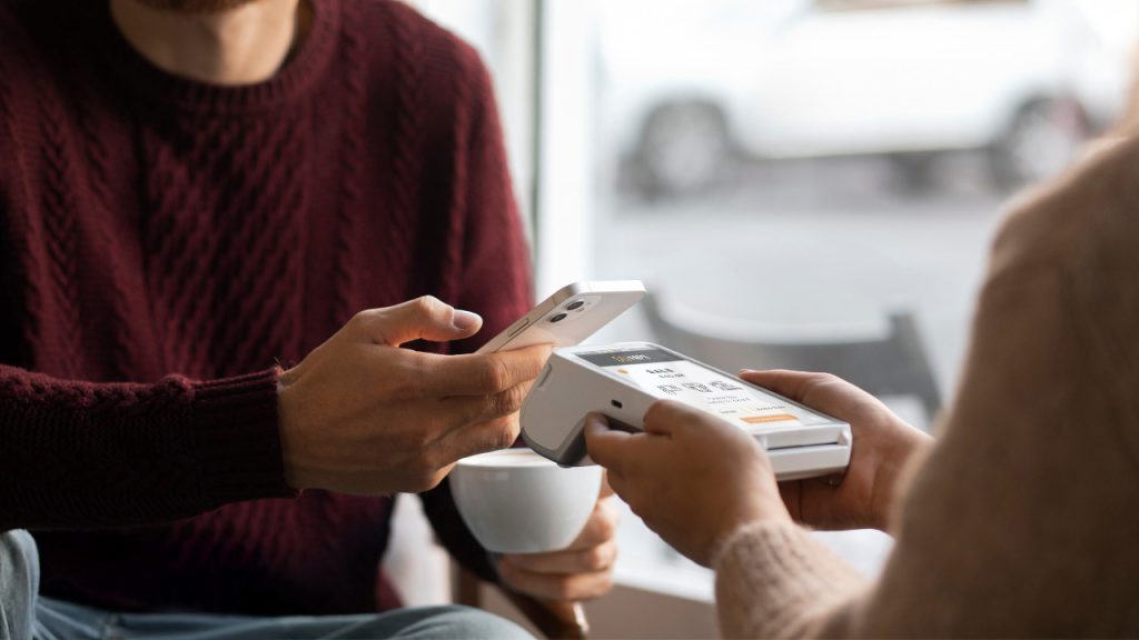 Payment solutions Ireland person making contactless payment cashless payments Ireland business payment solutions Ireland