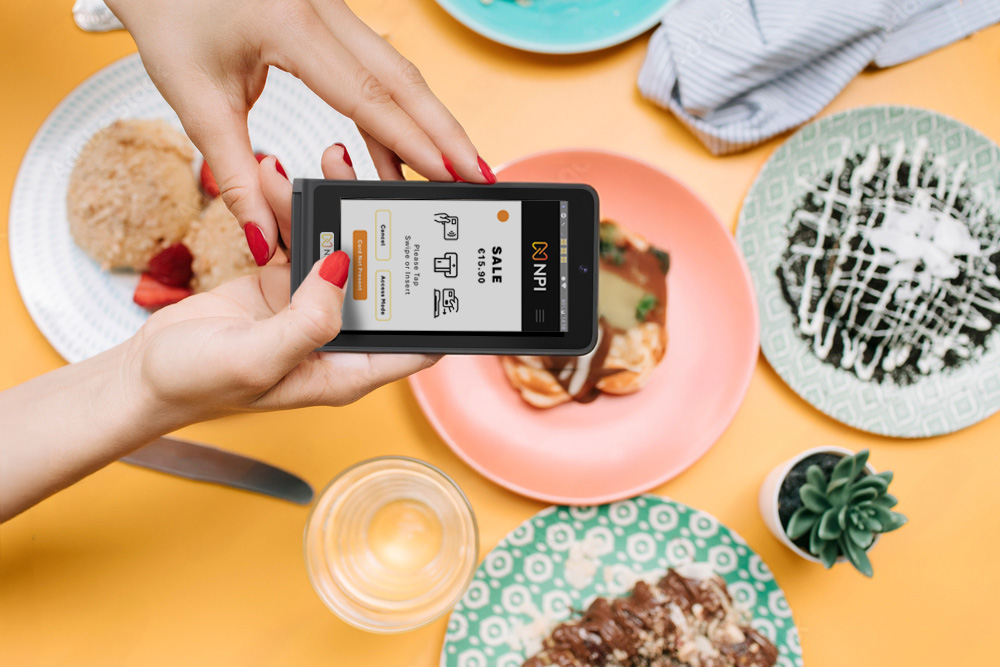 Restaurant EPOS Ireland person holding PAX S1 MINI 2 card machine hospitality POS Ireland cafe POS system Ireland