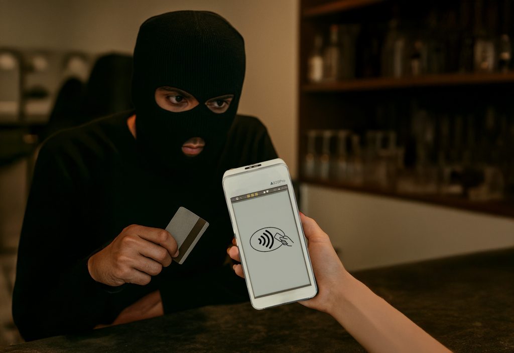 payment fraud prevention Ireland conceptual image showing thief making contactless payment highlighting card fraud protection Ireland security risks