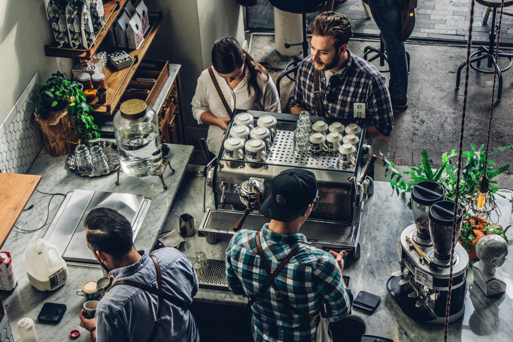 Card fraud prevention Ireland at a coffee shop counter with two customers making secure card payments