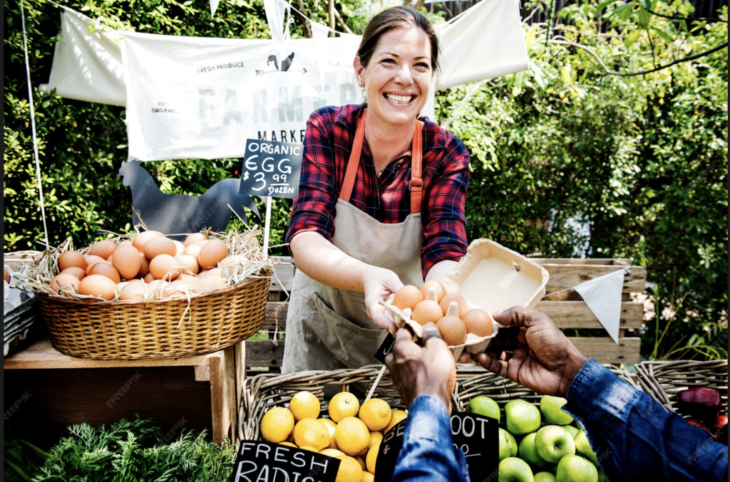 Smiling farmer selling fresh eggs and vegetables at farm shops and rural businesses accepting farm shop payments Ireland