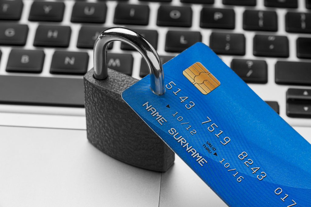 Credit card on security lock over laptop keyboard representing GDPR payment processing Ireland data protection