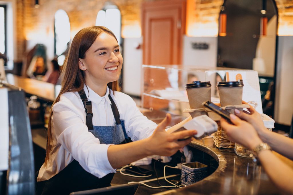 Barista using PAX A920 PRO card machine for payment solutions for Irish restaurants at Irish café counter