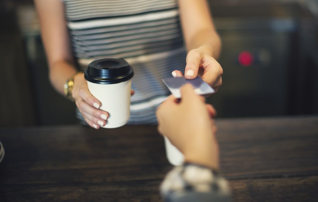 Customer making card payment at Irish coffee shop with card machine WiFi problems Ireland