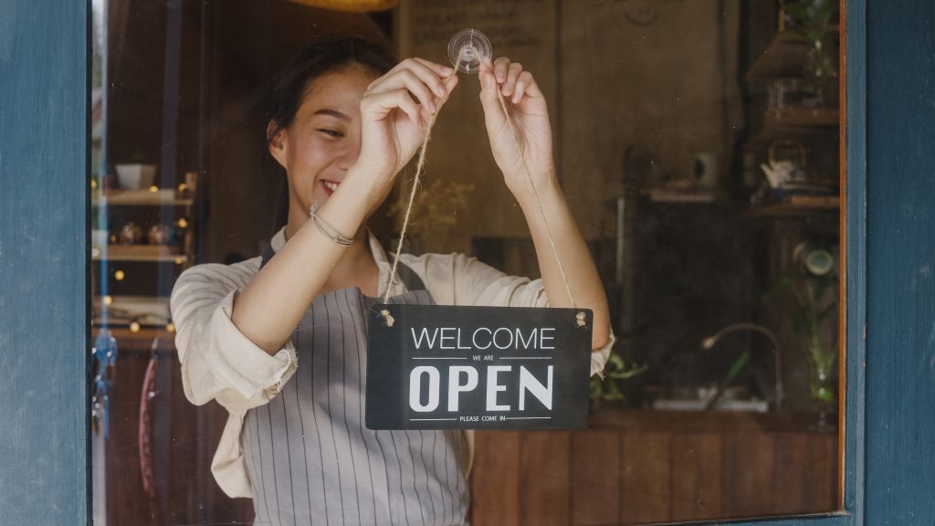 Small business owner opening shop ready to accept card payments for new business