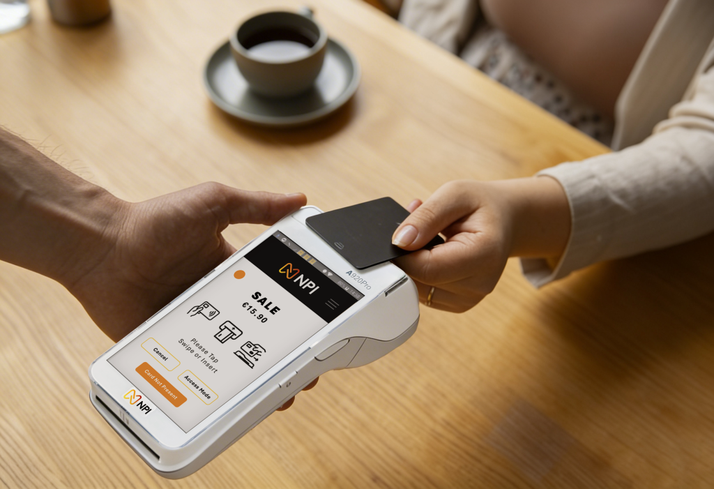 Customer tapping a card on an NPI PAX A920 Pro card machine in an Irish coffee shop low transaction rate